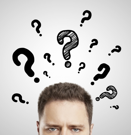 man with questions symbol on gray backgroundの写真素材
