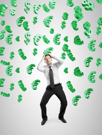 businessman concealed his hands from falling dollar and euro signsの写真素材