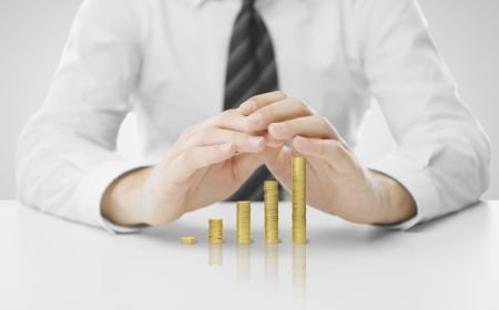 businessman hands covering coin graphの写真素材
