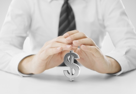 businessman hands covering sign dollarの写真素材