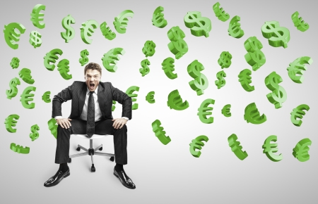 businessman sitting on chair and screaming with falling dollars and eurosの写真素材