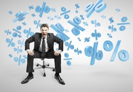 businessman sitting on chair and screaming with falling procentsの写真素材