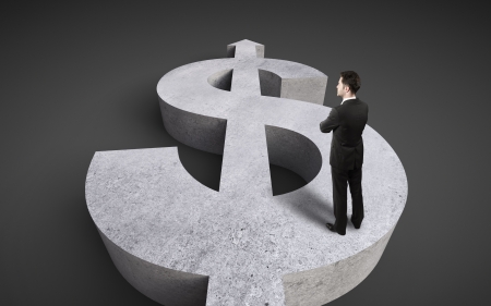 businessman standing on concrete dollar signの写真素材