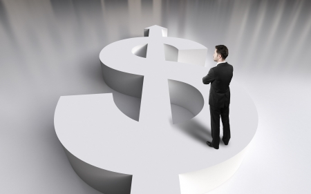 businessman standing on white dollar symbolの写真素材