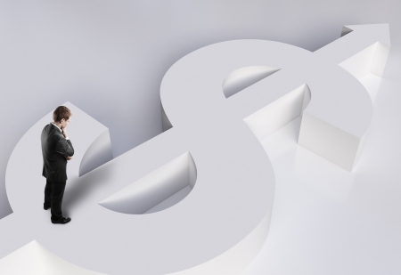 businessman standing on white dollar signの写真素材