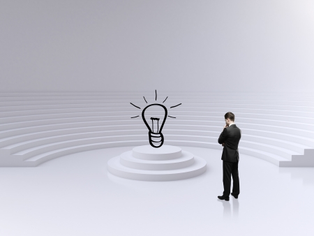 businessman looking on lamp in big circle roomの写真素材