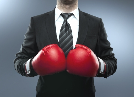 businessman in boxing gloves isolated on blueの写真素材