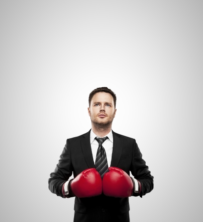 businessman in boxing gloves isolated on whiteの写真素材