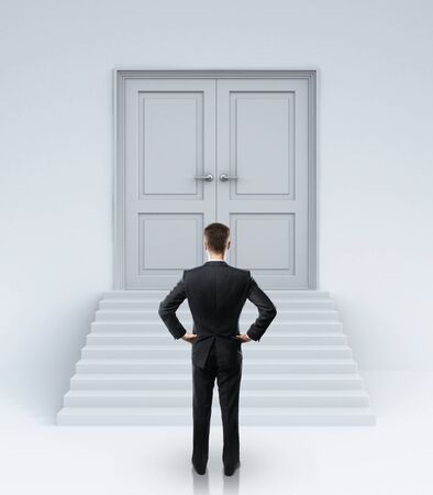 businessman looking at closed doorsの写真素材
