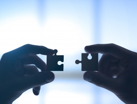 two hands collect puzzle, closeupの写真素材