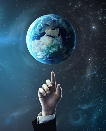 hand pointing at earth, space conceptの写真素材