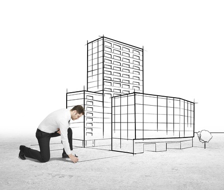 businessman drawing skyscraper on a white backgroundの写真素材
