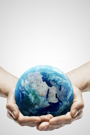 hands holding earth on gray backgroundの写真素材