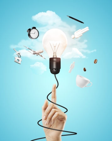 hand pointing on lamp with cable, travel conceptの写真素材