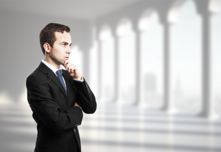 thinking businessman in office with columnの写真素材