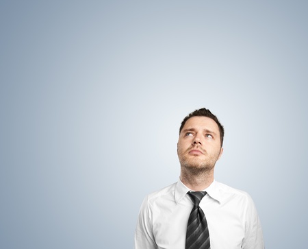 businessman thinking  on blue backgroundの写真素材