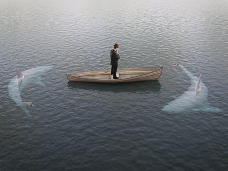 businessman thinking  boat with sharks around himの写真素材