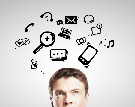 man looking at flying social media iconsの写真素材