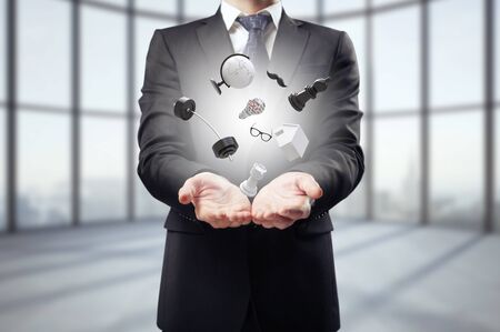 man holding mix of items in roomの写真素材