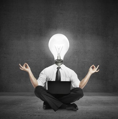 businessman sitting on concrete floor and  meditatingの写真素材