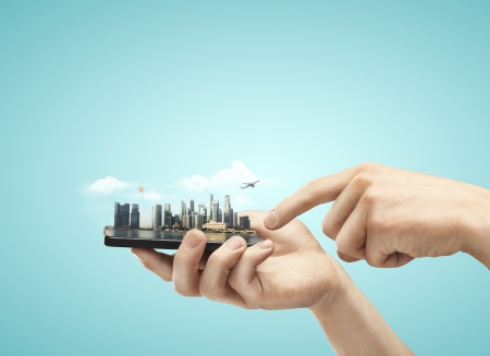 phone with model city in hands phone with model city in hands