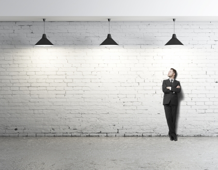 young businessman standing on loftの写真素材