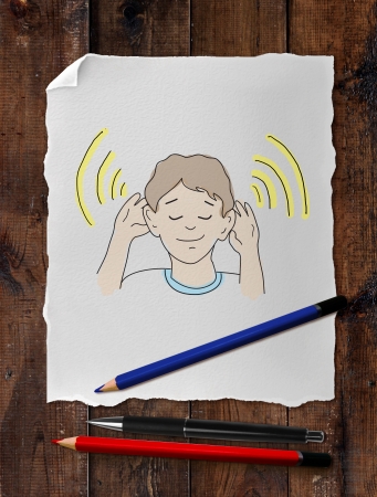 paper with drawing boy on wooden tableの写真素材