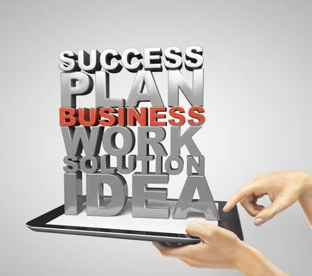 hands holding tablet with business words conceptの写真素材
