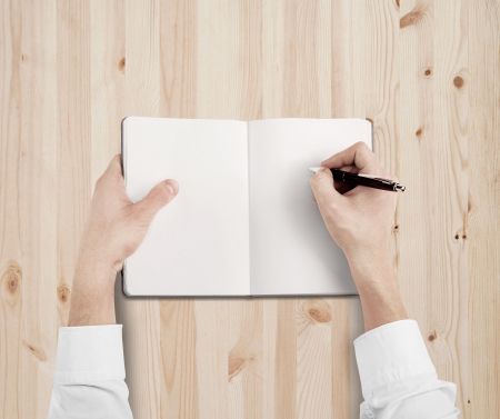hands drawing in notebook on tableの写真素材