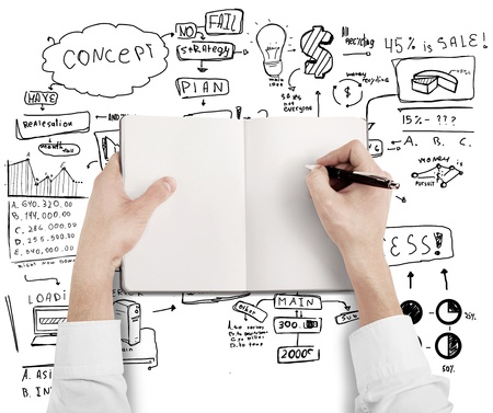 busnessman hands drawing on notebook on a business strategy backgroundの写真素材