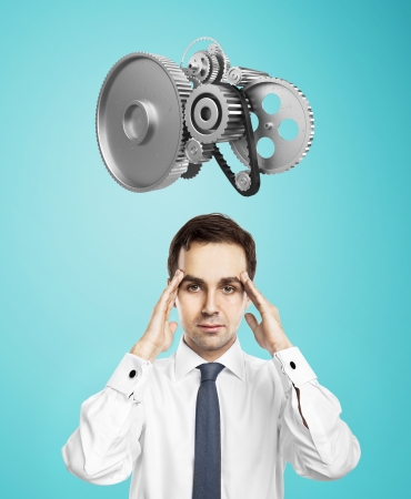 man with gears over headの写真素材