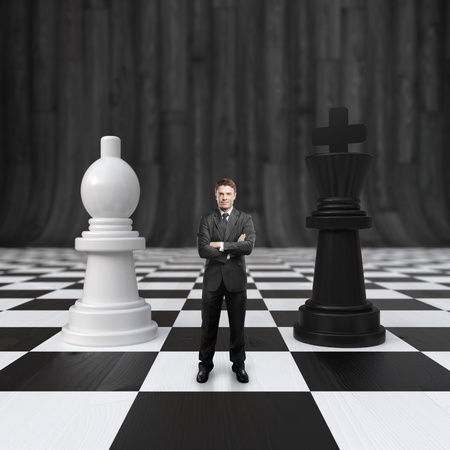 businessman standing on chessboard with chessの写真素材