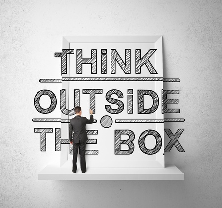businessman drawing think outside the box on shelfの写真素材