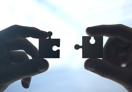 two hands collect the puzzleの写真素材