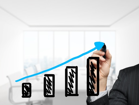 businessman drawing graph in officeの写真素材