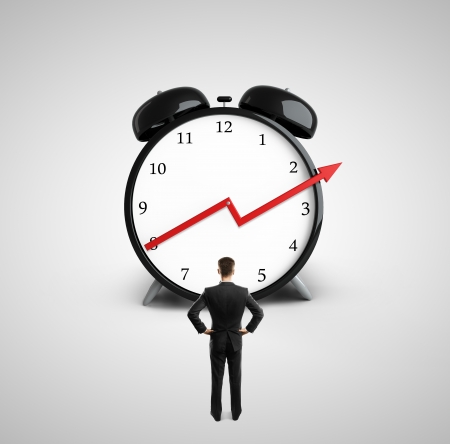 businessman looking at clock with growth red  arrowの写真素材
