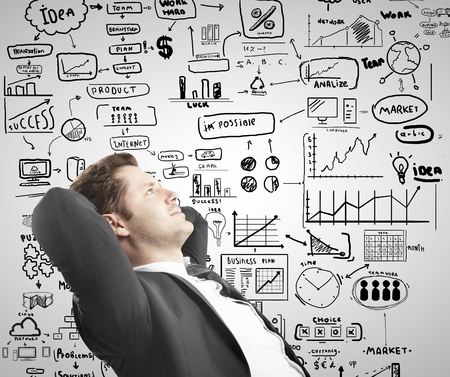 relaxed businessman sitting with drawing business conceptの写真素材