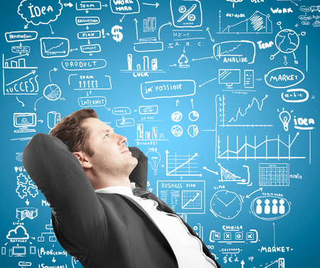 relaxed businessman sitting with drawing conceptの写真素材