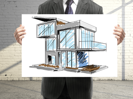 businessman holding paper with houseの写真素材
