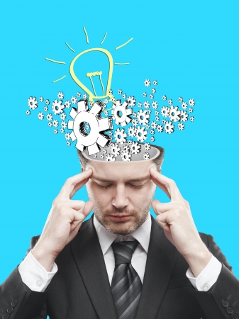 businessman with gears and lamp over headの写真素材