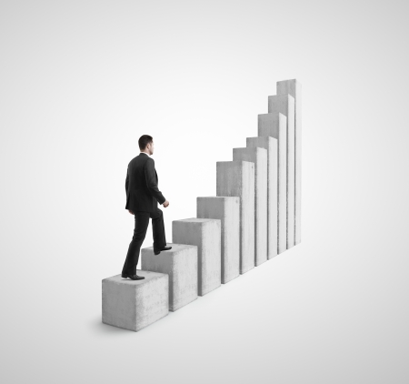 businessman climbing a graph columnの写真素材