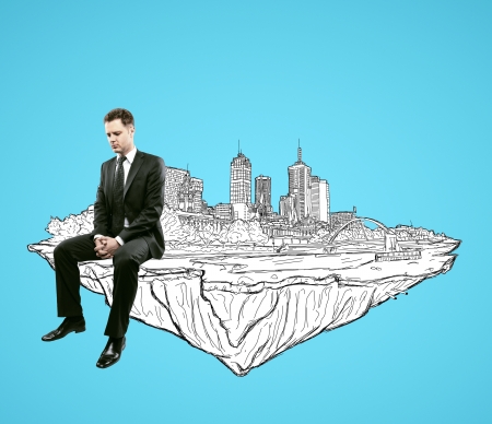 businessman sitting on abstract drawing city of the futureの写真素材