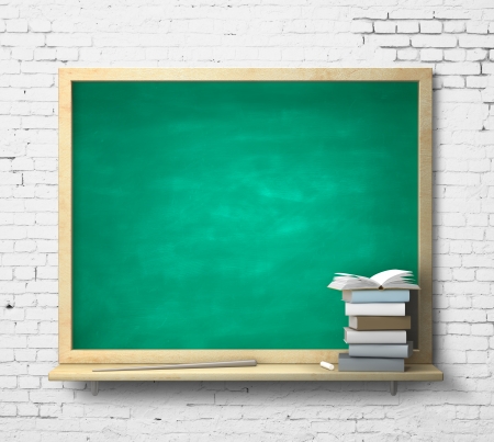 green blackboard and book on a brick wallの写真素材