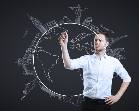 businessman drawing travel on a black backgroundの写真素材