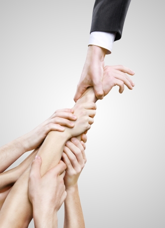 hand holding group hands on gray の写真素材