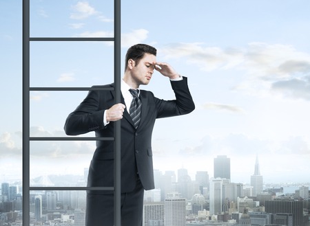 businessman climbing on ladder, urban business conceptの写真素材