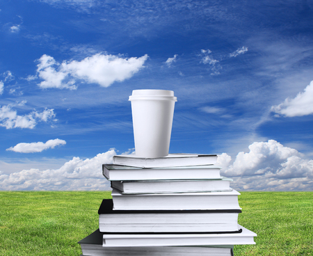 book and cup of coffee on a background of natureの写真素材