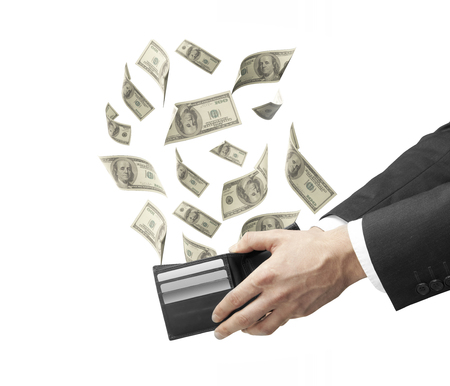 businessman hand holding a purse from which emerge dollarsの写真素材