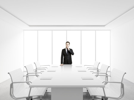 businessman thinking in white officeの写真素材