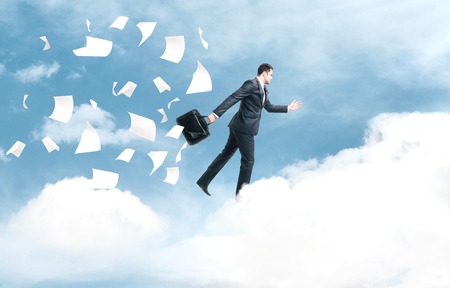 businessman jumping from cloud to another cloudの写真素材
